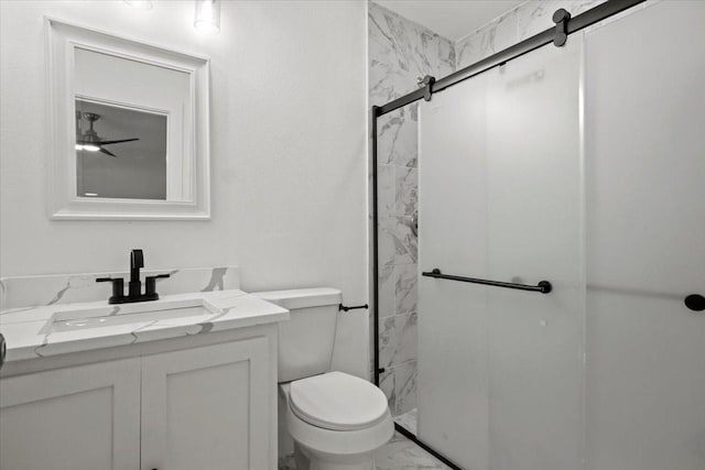 bathroom with vanity, toilet, and a shower with door