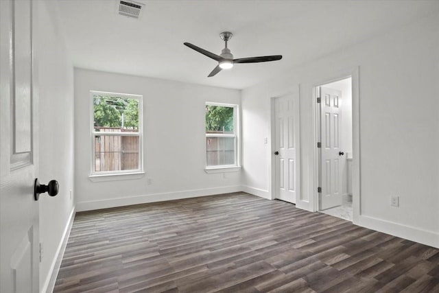 unfurnished bedroom with ceiling fan and dark wood-type flooring