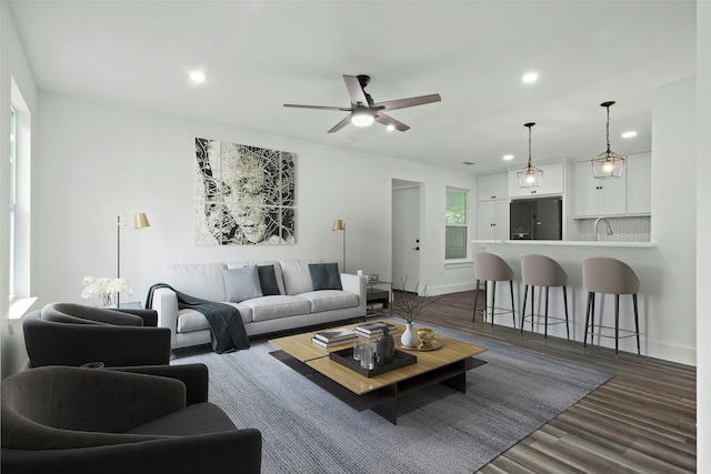 living room with baseboards, a ceiling fan, dark wood-style flooring, and recessed lighting