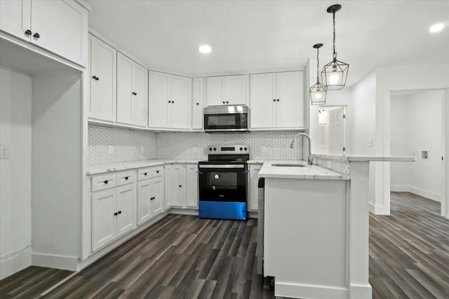 kitchen featuring sink, white cabinetry, stainless steel appliances, and hanging light fixtures