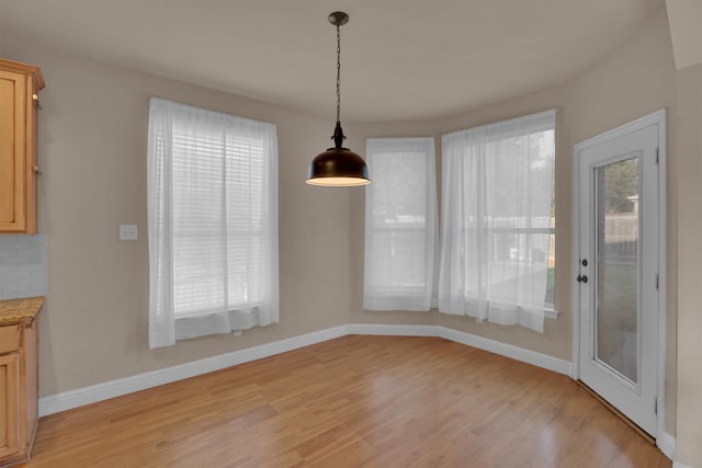 unfurnished dining area featuring light hardwood / wood-style floors