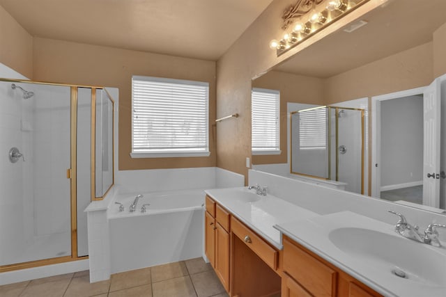 bathroom featuring vanity, plus walk in shower, and tile patterned flooring