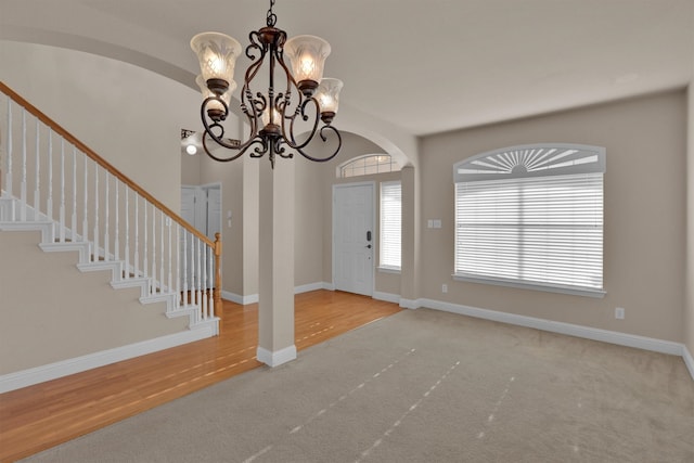 foyer featuring an inviting chandelier and light hardwood / wood-style flooring