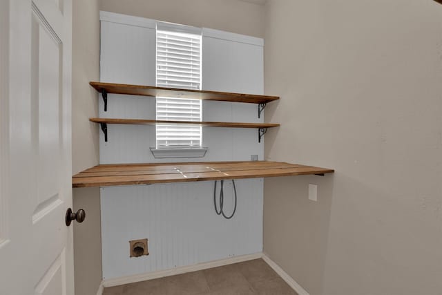 laundry room with light tile patterned floors and hookup for an electric dryer