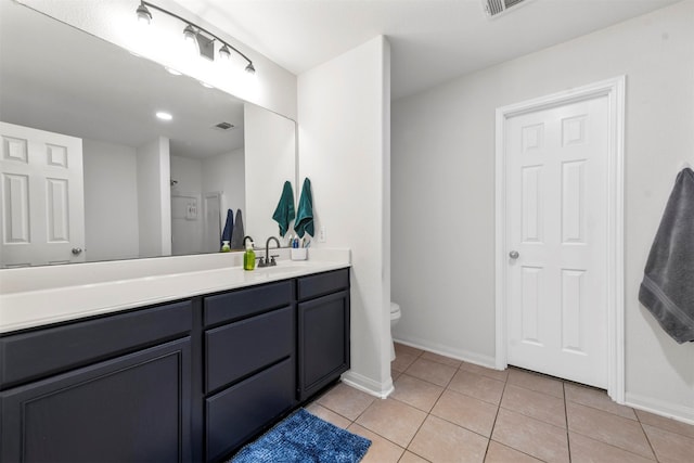 bathroom with walk in shower, vanity, toilet, and tile patterned floors