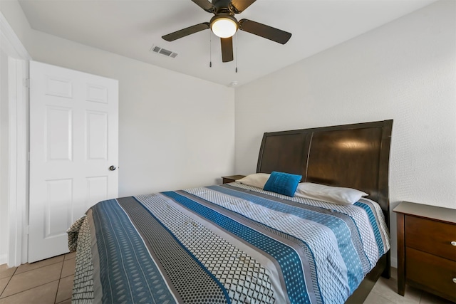 tiled bedroom featuring ceiling fan