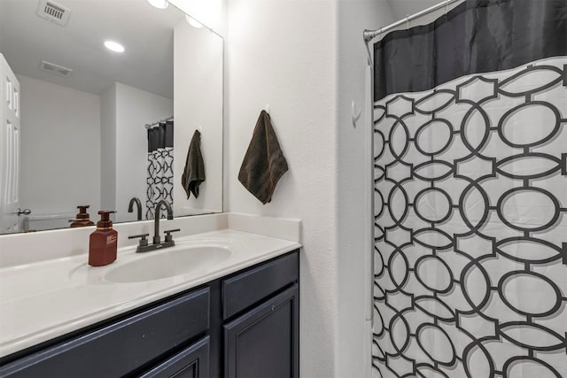 bathroom with vanity and curtained shower