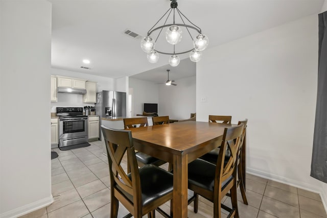 dining room with ceiling fan with notable chandelier and light tile patterned floors