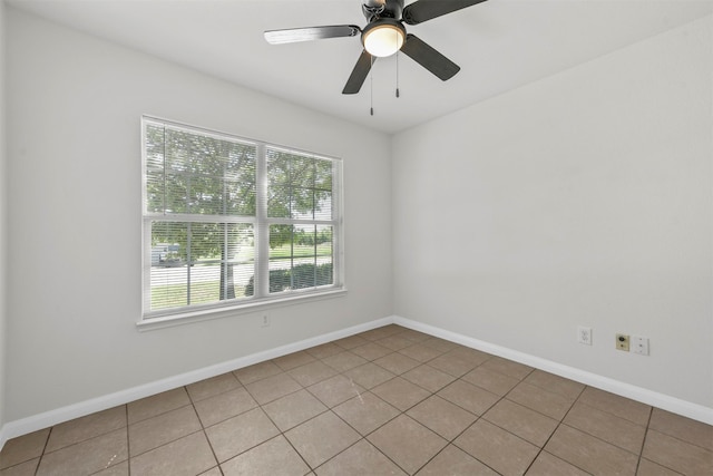 tiled empty room featuring ceiling fan