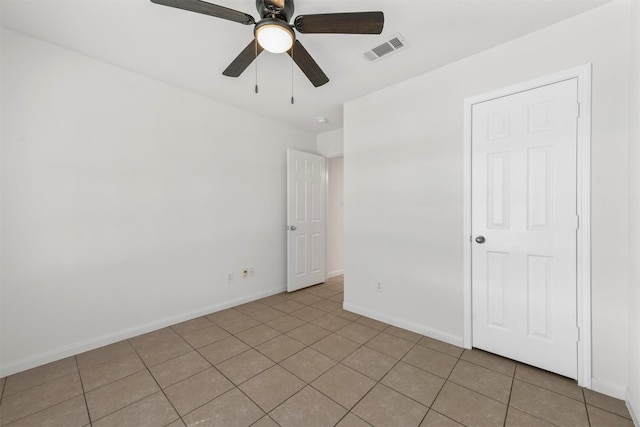 unfurnished room featuring ceiling fan and light tile patterned floors