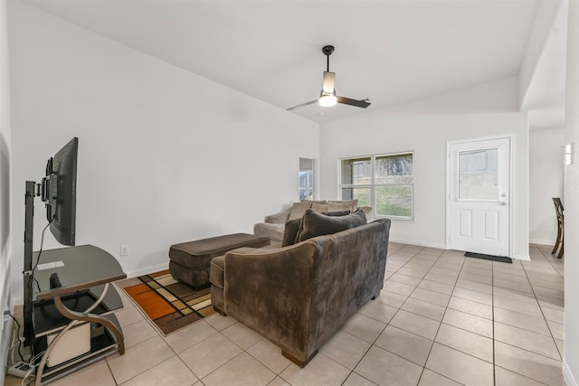 living room featuring ceiling fan, lofted ceiling, and light tile patterned floors