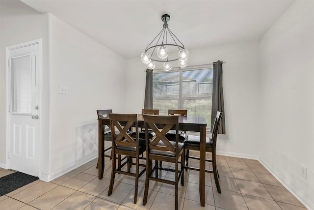 dining room featuring a chandelier and light tile patterned flooring