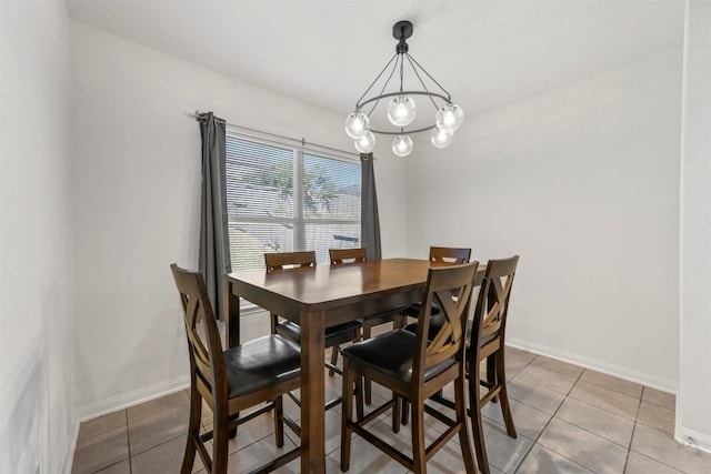 dining room with a chandelier and light tile patterned floors