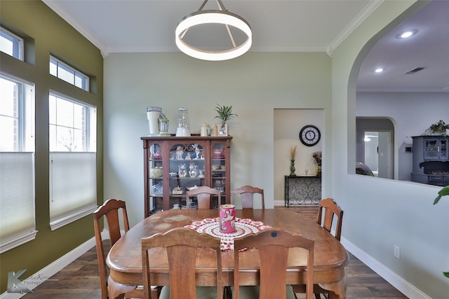 dining area with crown molding and dark hardwood / wood-style flooring