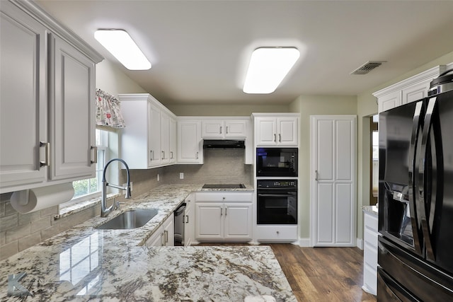 kitchen featuring white cabinets, dark hardwood / wood-style flooring, sink, black appliances, and decorative backsplash