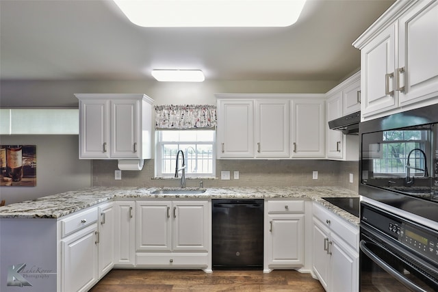 kitchen featuring dark hardwood / wood-style flooring, black appliances, sink, light stone counters, and white cabinets