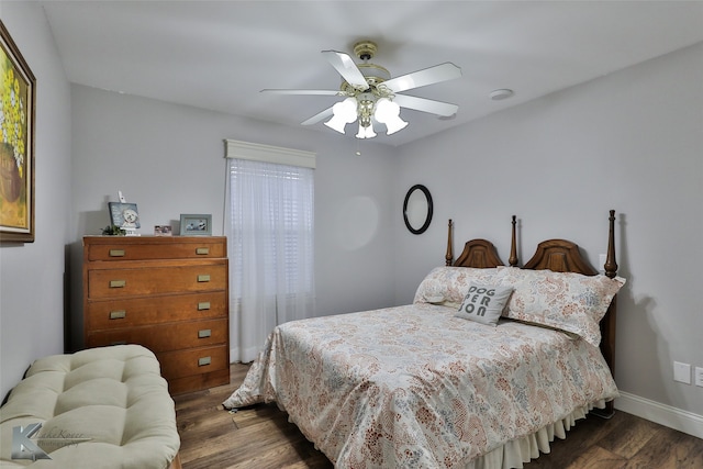 bedroom featuring dark wood-type flooring, multiple windows, and ceiling fan