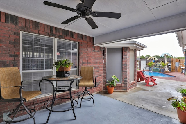 view of patio / terrace with ceiling fan and a fenced in pool