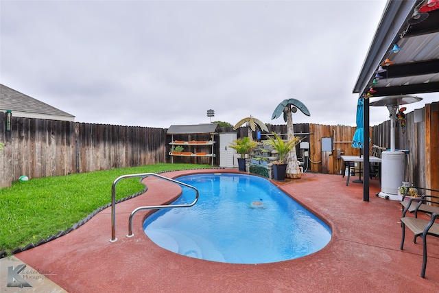 view of pool with a lawn and a patio