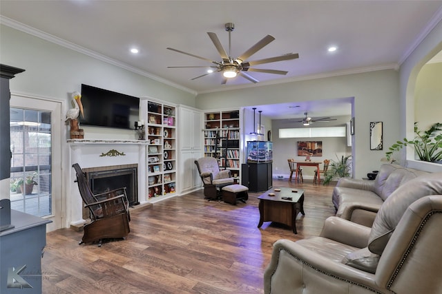 living room with ornamental molding, hardwood / wood-style flooring, and ceiling fan