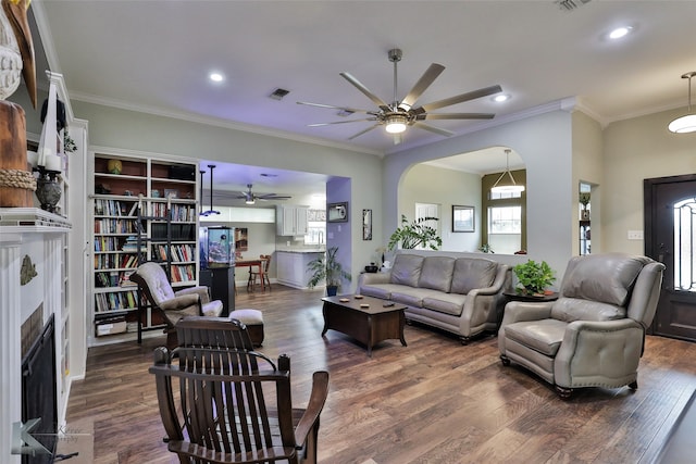 living room featuring ornamental molding, ceiling fan, and dark hardwood / wood-style floors