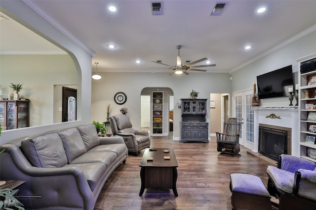 living room featuring ornamental molding, dark hardwood / wood-style flooring, and ceiling fan