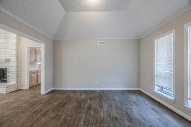 unfurnished living room with a textured ceiling, lofted ceiling, crown molding, and dark wood-type flooring