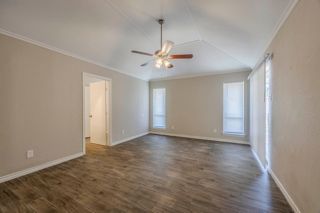 empty room with lofted ceiling, crown molding, ceiling fan, and dark wood-type flooring