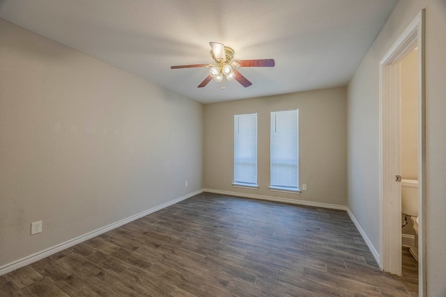 empty room featuring dark hardwood / wood-style floors and ceiling fan