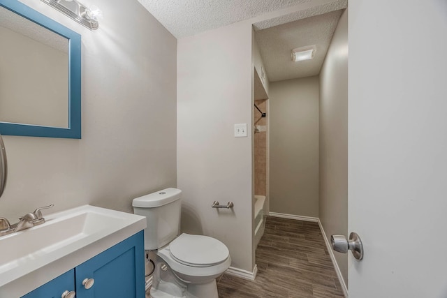 full bathroom featuring a textured ceiling, toilet, shower / tub combination, vanity, and hardwood / wood-style flooring