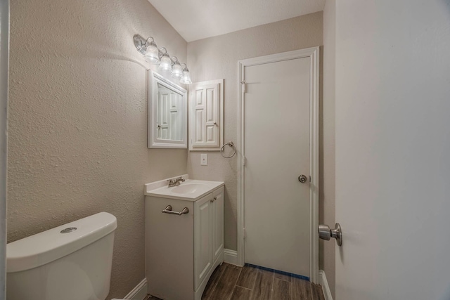 bathroom featuring hardwood / wood-style floors, vanity, and toilet