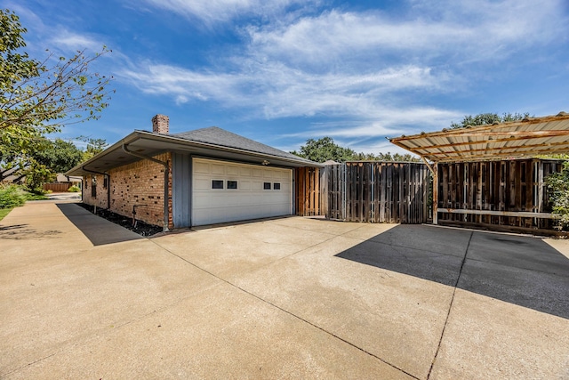 view of side of home with a garage and a carport