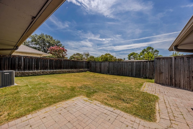 view of yard featuring a patio area and central air condition unit