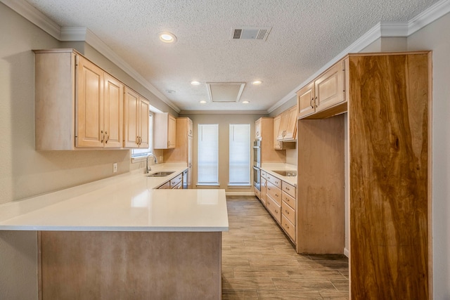 kitchen featuring kitchen peninsula, light brown cabinetry, light wood-type flooring, and crown molding