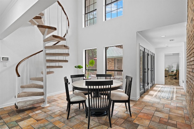 6005 Englishoak Dr, Arlington, TX 76016 - dining space with stone tile floors, stairway, a towering ceiling, and recessed lighting