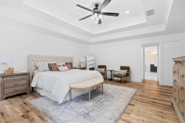 bedroom featuring ornamental molding, a raised ceiling, ceiling fan, and light hardwood / wood-style floors