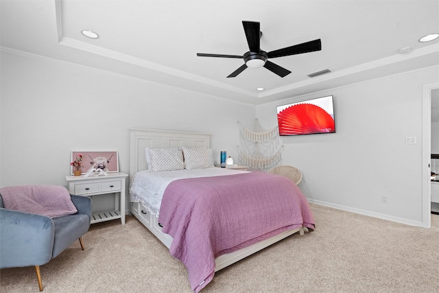 carpeted bedroom with ceiling fan, a raised ceiling, and crown molding