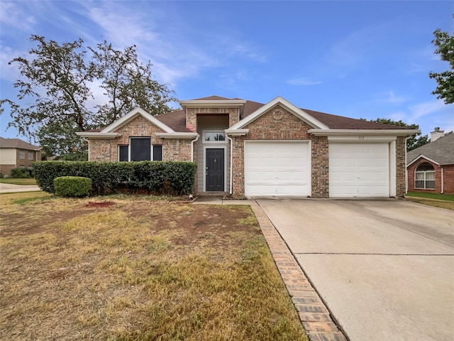 view of front of home with a garage and a front lawn