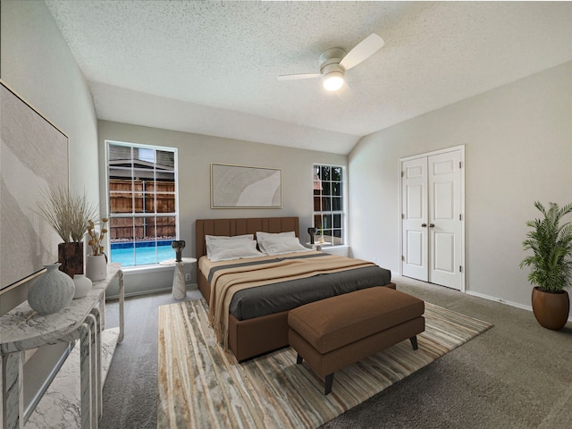 bedroom featuring a textured ceiling, ceiling fan, carpet floors, and vaulted ceiling