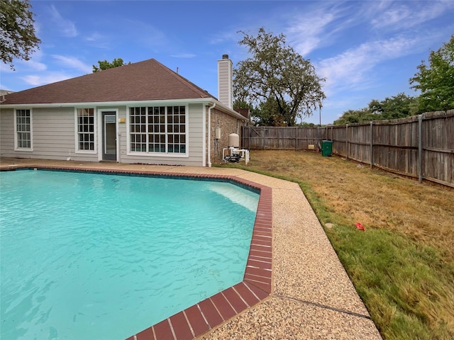 view of pool with a lawn