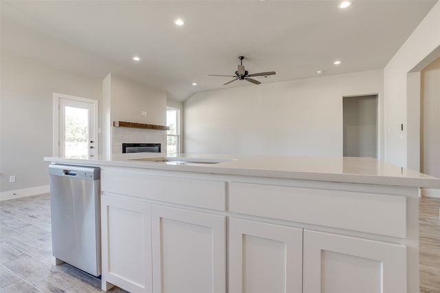 kitchen featuring white cabinetry, ceiling fan, stainless steel dishwasher, light hardwood / wood-style flooring, and a center island