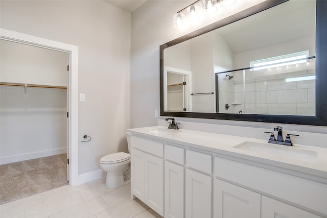 bathroom with toilet, vanity, tile patterned floors, and a shower with shower door