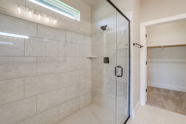 bathroom featuring walk in shower and tile patterned floors