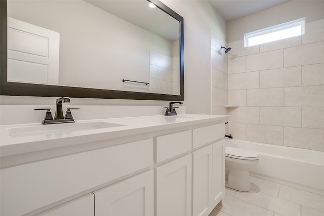 full bathroom featuring toilet, vanity, tiled shower / bath, and tile patterned flooring