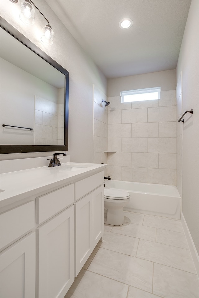 full bathroom featuring toilet, tile patterned floors, a textured ceiling, tiled shower / bath combo, and vanity