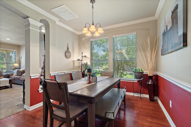 dining room with crown molding, plenty of natural light, and dark wood-type flooring