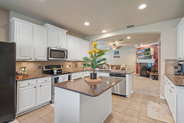 kitchen featuring appliances with stainless steel finishes, a center island, and white cabinetry