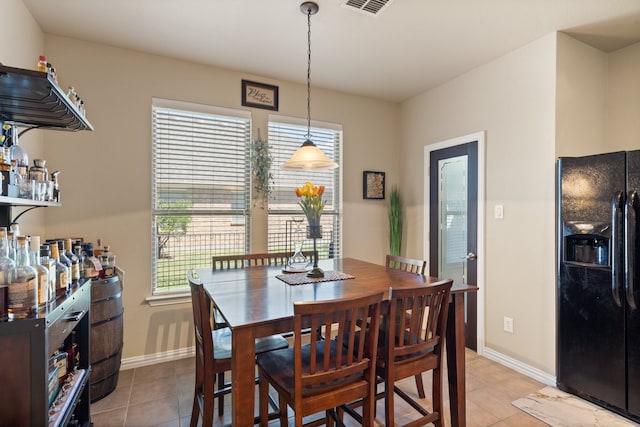 dining space with plenty of natural light and light tile patterned floors