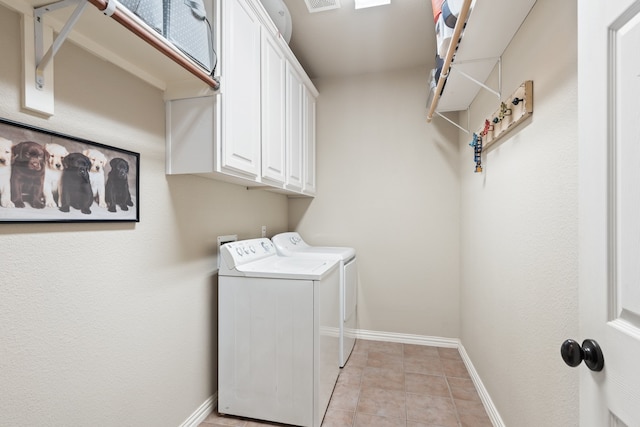 laundry area with separate washer and dryer, light tile patterned floors, and cabinets