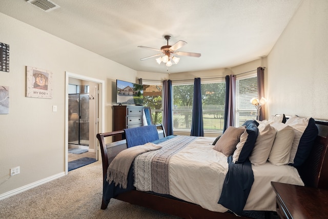 bedroom with ceiling fan, carpet, and a textured ceiling